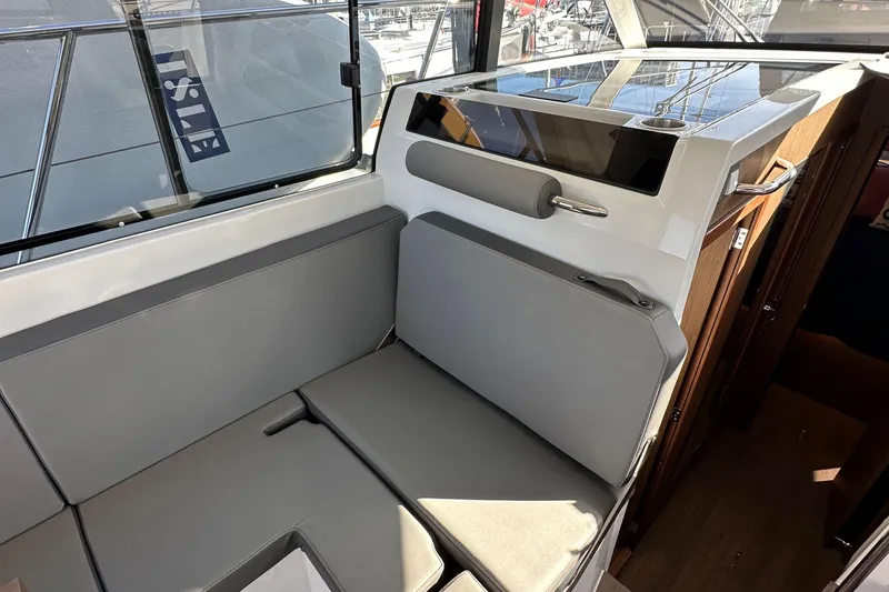 Slide: The Image of Interior seating area of 2023 Beneteau Antares 11 Fly, featuring modern design and comfortable cushions. - 30