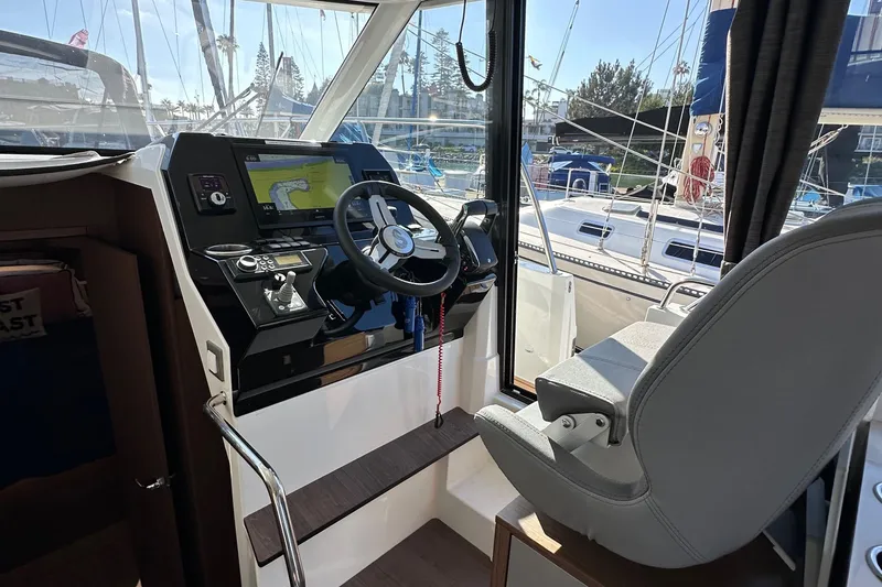 Slide: The Image of Interior helm of 2023 Beneteau Antares 11 Fly with navigation controls and steering wheel. - 36