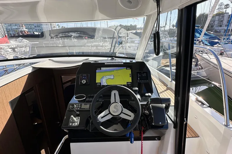 Slide: The Image of Helm of 2023 Beneteau Antares 11 Fly with navigation display and controls. - 37