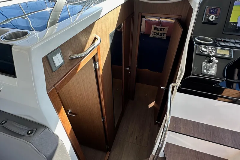 Slide: The Image of Interior view of 2023 Beneteau Antares 11 Fly, featuring wooden cabinetry and control panel. - 46