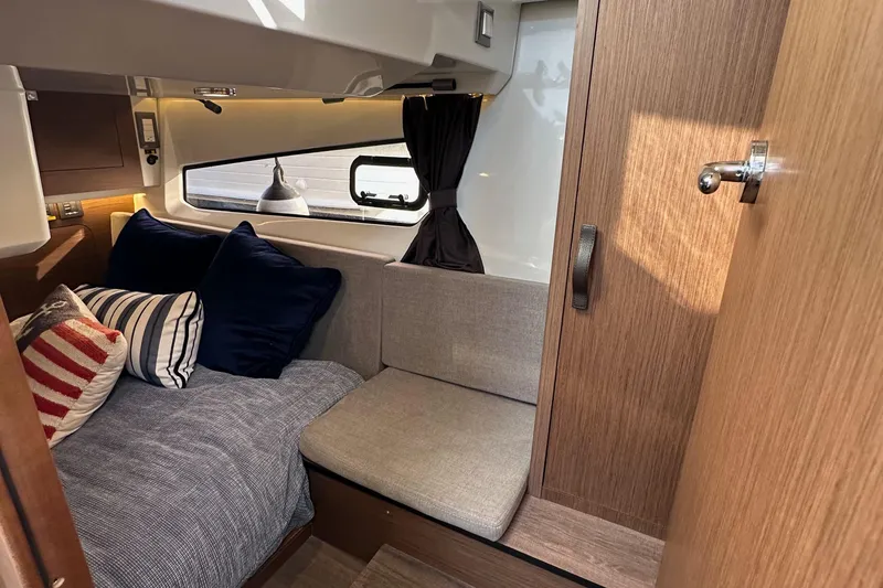 Slide: The Image of 2023 Beneteau Antares 11 Fly cabin interior with cozy seating and nautical decor. - 47
