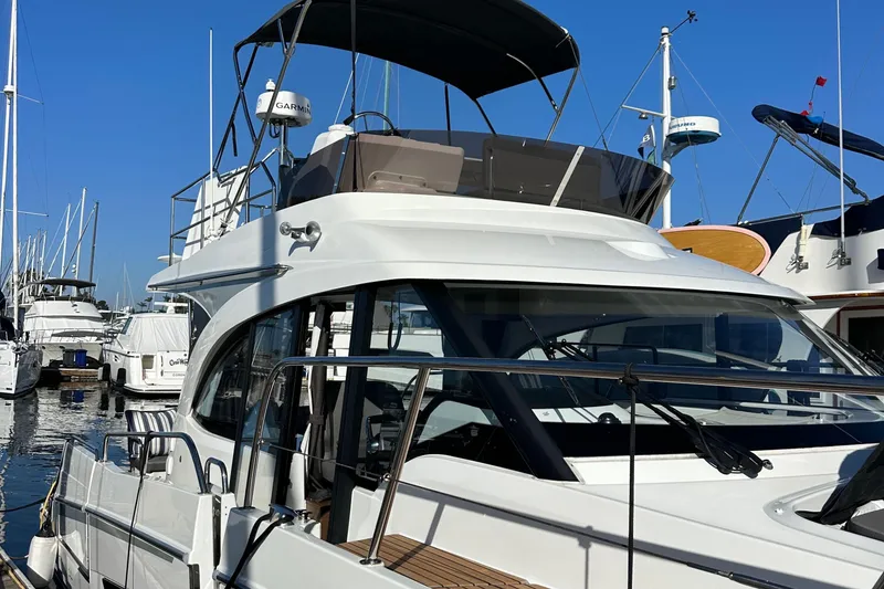 Slide: The Image of 2023 Beneteau Antares 11 Fly yacht docked at marina under clear blue sky. - 5