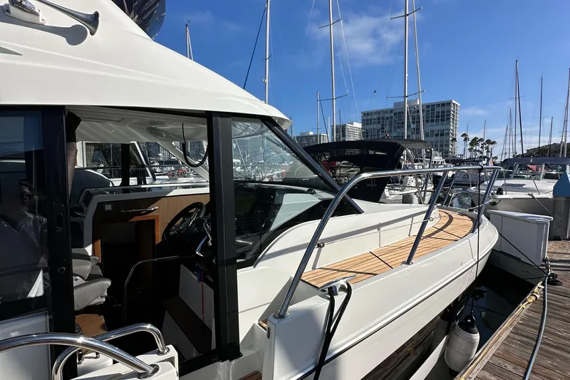 Slide: The Image of 2023 Beneteau Antares 11 Fly yacht docked at marina, showcasing sleek design and modern features. - 6