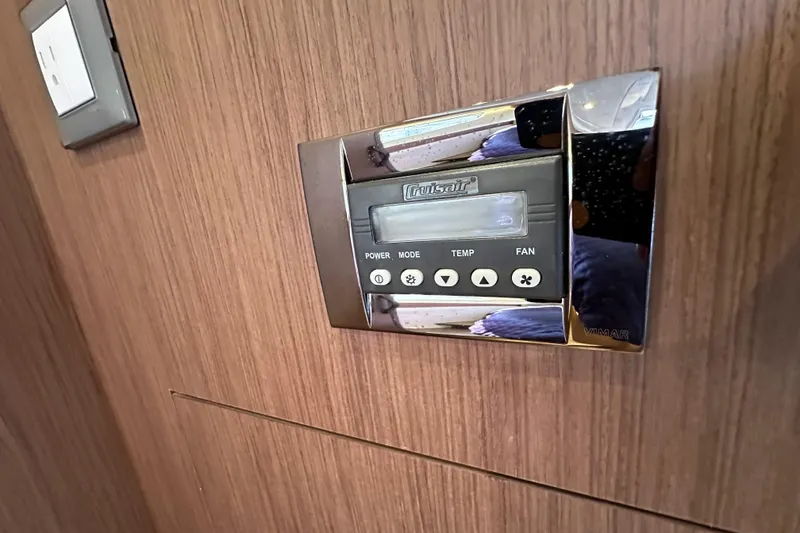 Slide: The Image of Control panel on 2023 Beneteau Antares 11 Fly yacht, featuring wood paneling and modern design. - 69