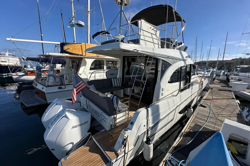 Slide: The Image of 2023 Beneteau Antares 11 Fly yacht docked at marina with Mercury engines. - 7
