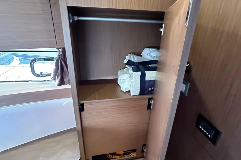 Slide: The Image of Interior storage of 2023 Beneteau Antares 11 Fly yacht with open wooden cabinet. - 70