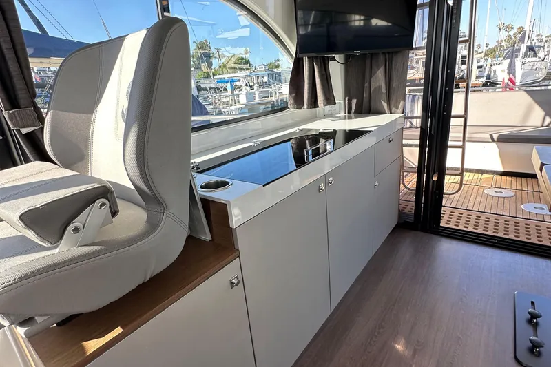 Slide: The Image of Interior of 2023 Beneteau Antares 11 Fly, featuring modern helm and sleek cabinetry. - 74