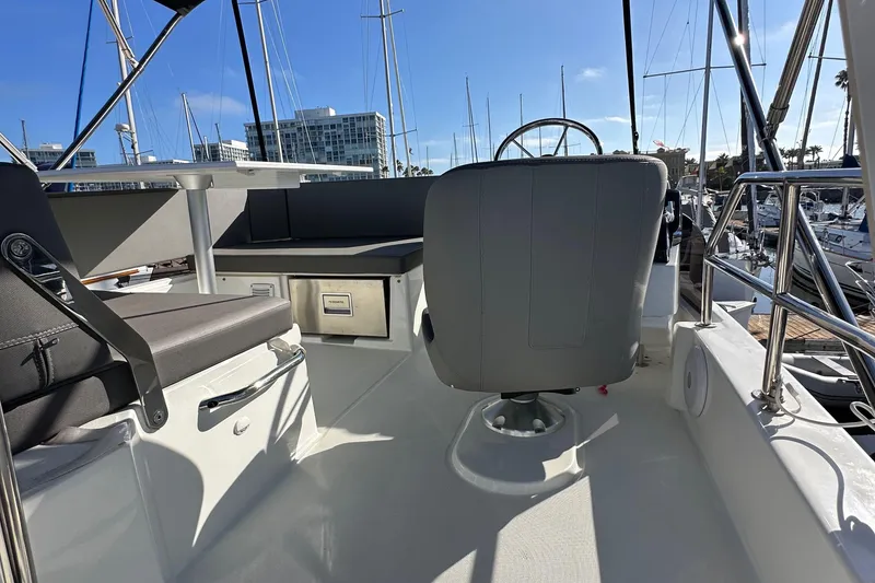 Slide: The Image of Flybridge of 2023 Beneteau Antares 11 Fly with seating and helm, docked in marina. - 78