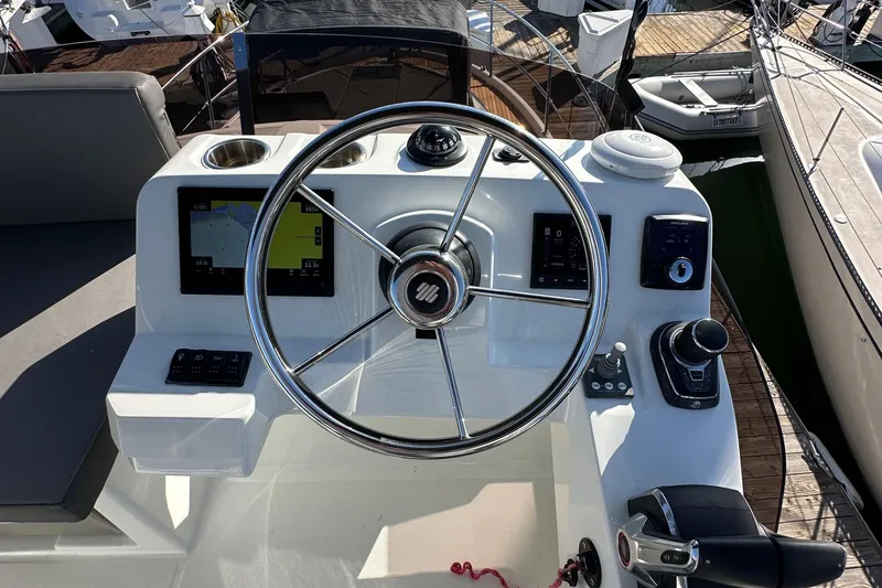 Slide: The Image of 2023 Beneteau Antares 11 Fly helm with modern controls and navigation displays. - 81