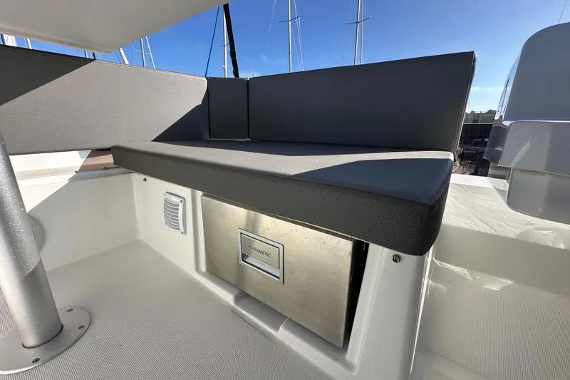 Slide: The Image of 2023 Beneteau Antares 11 Fly seating area with integrated storage and modern design. - 82