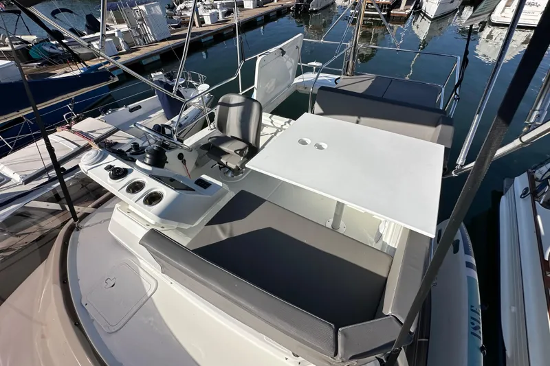 Slide: The Image of 2023 Beneteau Antares 11 Flybridge with seating and control panel at marina. - 85