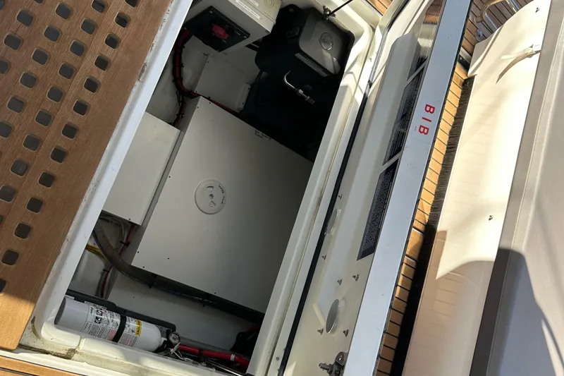 Slide: The Image of 2023 Beneteau Antares 11 Fly engine compartment with safety equipment and storage. - 88