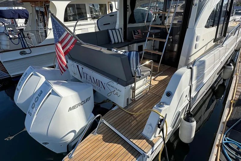 Slide: The Image of 2023 Beneteau Antares 11 Fly with Mercury engines, docked with American flag. - 9