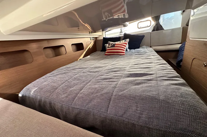 Slide: The Image of Cozy cabin interior of 2023 Beneteau Antares 11 Fly with stylish bedding and cushions. - 96