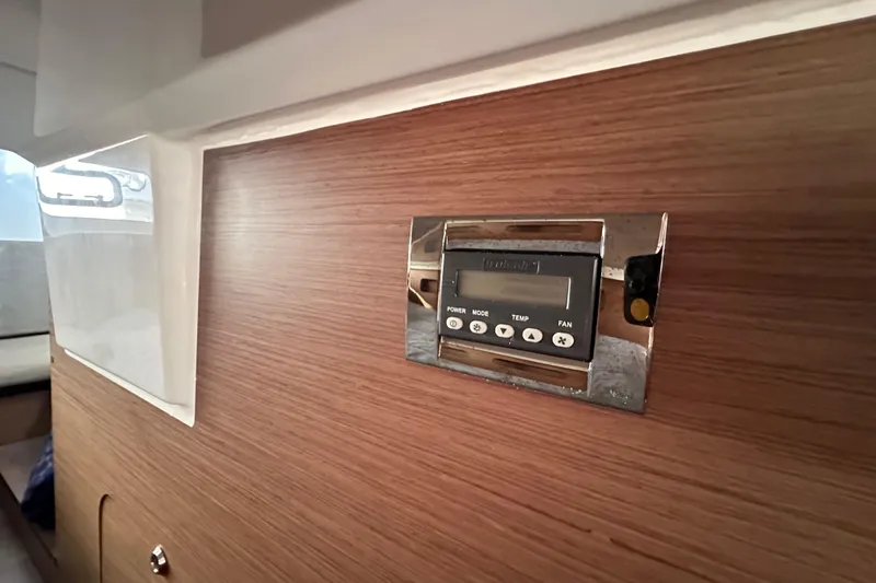 Slide: The Image of Control panel on 2023 Beneteau Antares 11 Fly's wooden interior wall. - 98