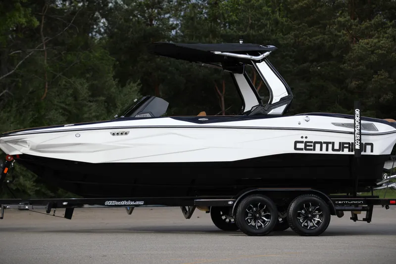 The Image of 2025 Centurion Nv213 boat on trailer, sleek design, white and black color scheme. - 0