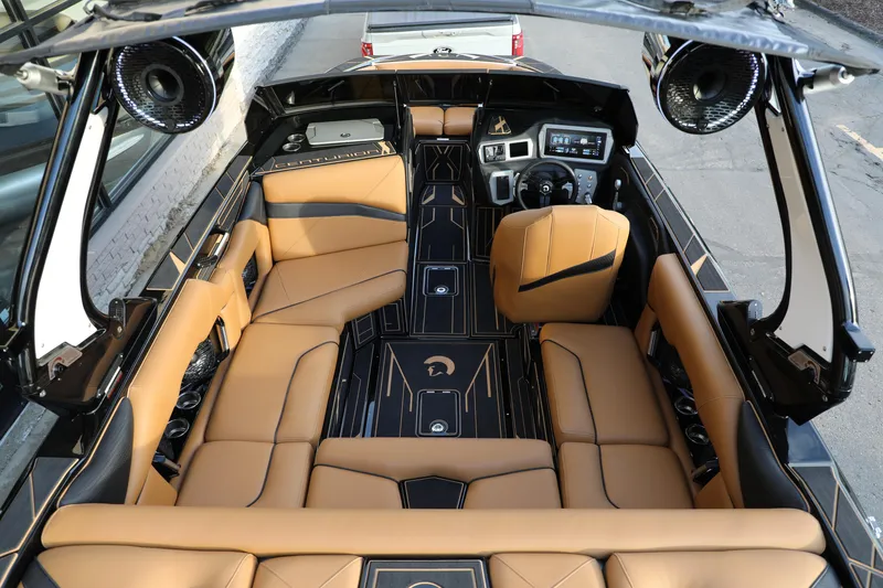 Slide: The Image of Luxurious interior of 2025 Centurion Nv213 boat with tan leather seating and modern dashboard. - 11