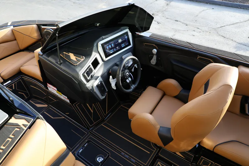 Slide: The Image of Luxurious interior of 2025 Centurion Nv213 boat with modern dashboard and tan seating. - 12