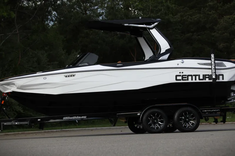 Slide: The Image of 2025 Centurion Nv213 boat on trailer, sleek design, parked outdoors. - 18