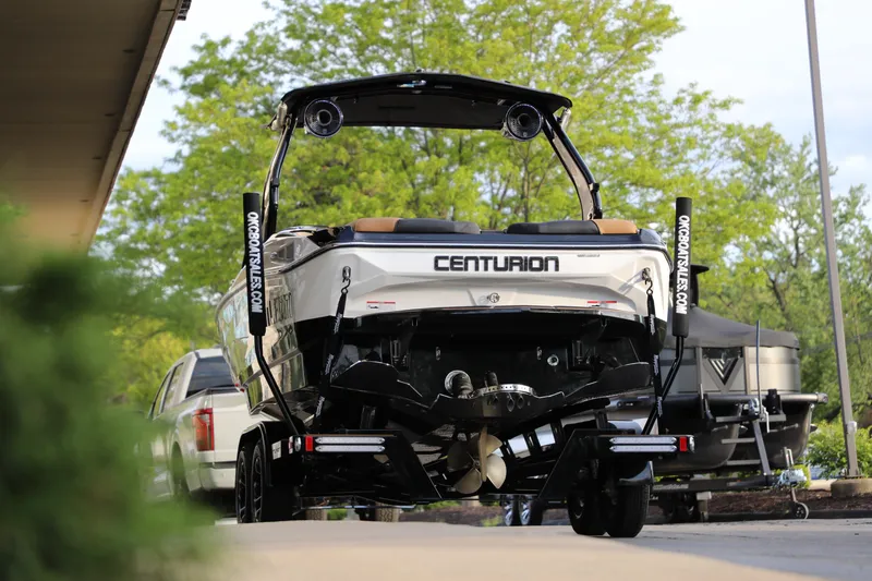 Slide: The Image of 2025 Centurion Nv213 boat on trailer, rear view, parked outdoors. - 27