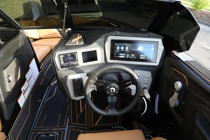 Slide: The Image of Interior of 2025 Centurion Nv213 boat with advanced dashboard and steering wheel. - 28