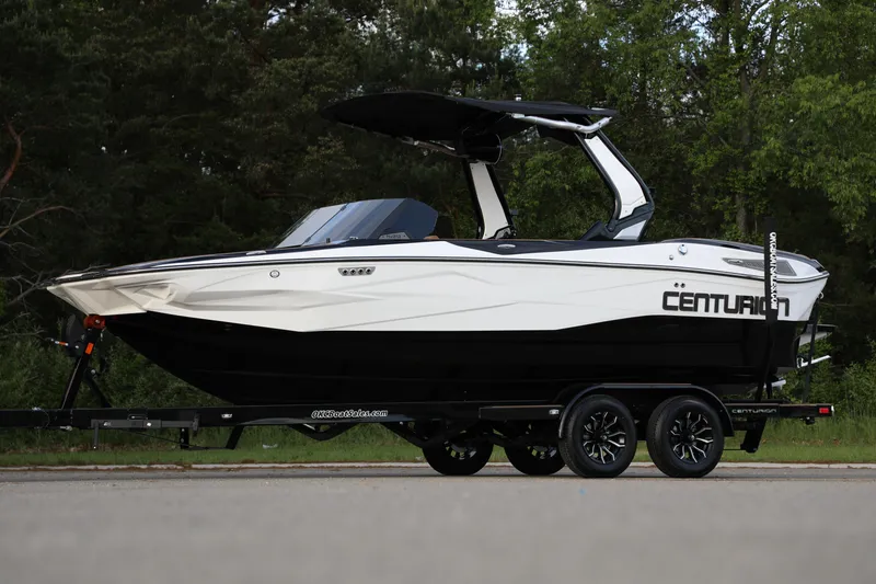 Slide: The Image of 2025 Centurion Nv213 boat on trailer, sleek design, parked outdoors. - 31