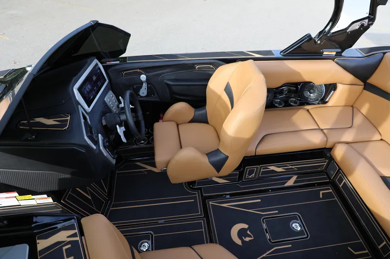 Slide: The Image of Luxurious interior of 2025 Centurion Nv213 boat with tan leather seating and modern dashboard. - 41