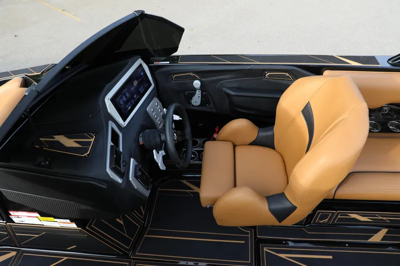 Slide: The Image of Luxurious interior of 2025 Centurion Nv213 boat with tan leather seating and modern dashboard. - 43