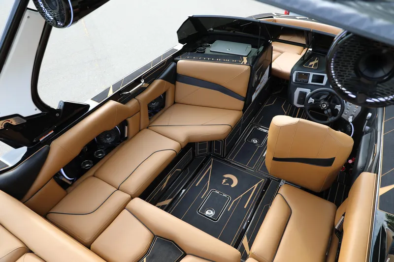 Slide: The Image of Luxurious interior of 2025 Centurion Nv213 boat with tan leather seating and modern dashboard. - 44