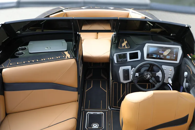 Slide: The Image of Luxurious interior of 2025 Centurion Nv213 boat with advanced dashboard and tan leather seating. - 6