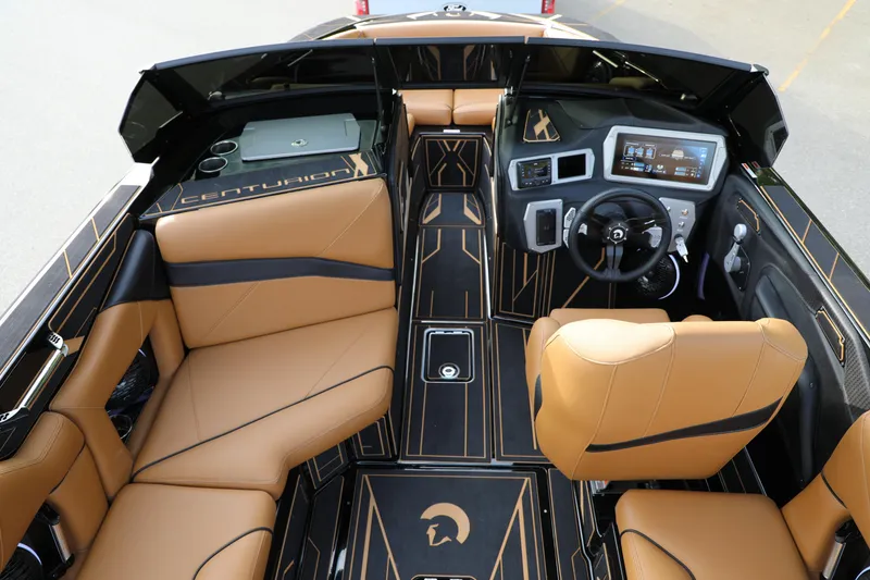 Slide: The Image of Interior of 2025 Centurion Nv213 boat with tan leather seats and modern dashboard. - 9
