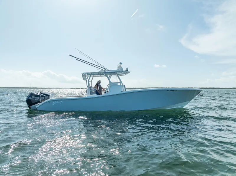 Slide: The Image of 2020 Yellowfin 34 boat cruising on open water under clear skies. - 10