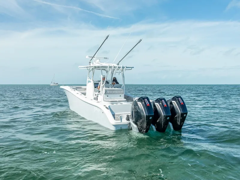 Slide: The Image of 2020 Yellowfin 34 boat with triple outboard engines on open water. - 11