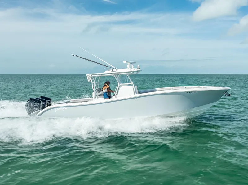 Slide: The Image of 2020 Yellowfin 34 boat cruising on open water under clear skies. - 17