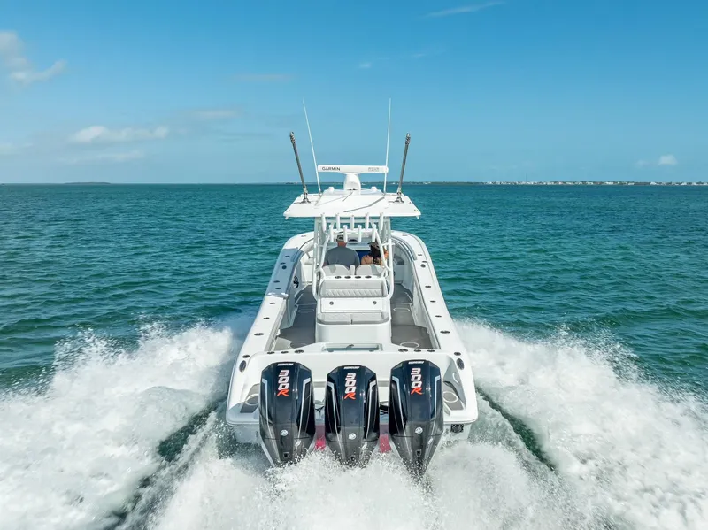 Slide: The Image of 2020 Yellowfin 34 boat cruising on open water with triple outboard engines. - 19