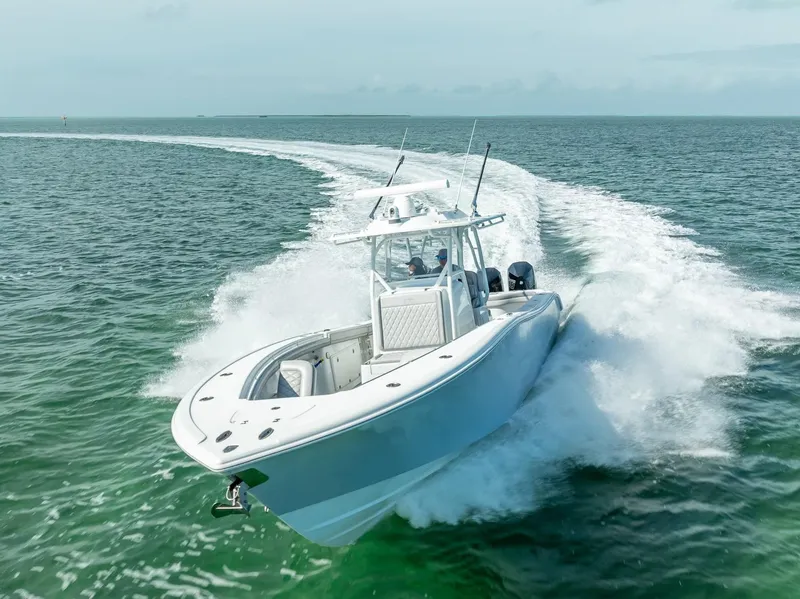Slide: The Image of 2020 Yellowfin 34 boat cruising on open water, creating a dynamic wake. - 22