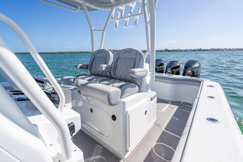 Slide: The Image of 2020 Yellowfin 34 boat interior with cushioned seating and multiple outboard motors. - 36