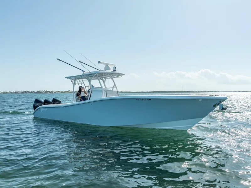 Slide: The Image of 2020 Yellowfin 34 boat cruising on open water under clear skies. - 8