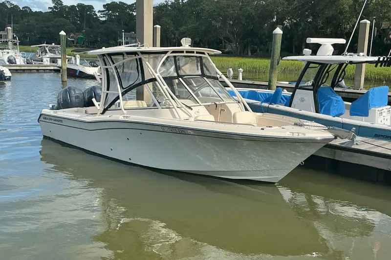 The Image of 2020 Grady-White Freedom 225 boat docked in a marina setting. - 1