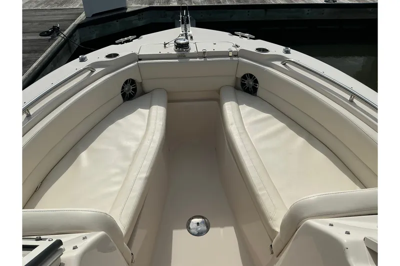 Slide: The Image of 2020 Grady-White Freedom 225 boat interior with white cushioned seating. - 10