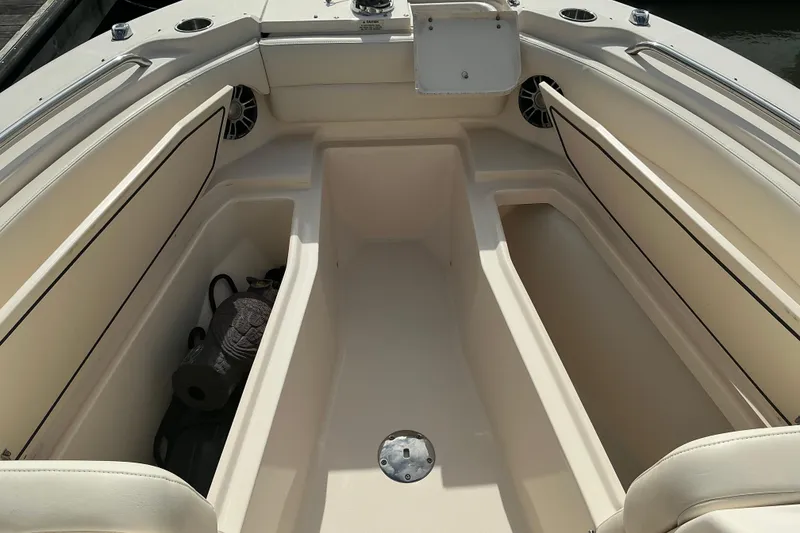 Slide: The Image of 2020 Grady-White Freedom 225 boat interior with spacious seating and storage compartments. - 11
