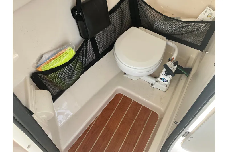 Slide: The Image of 2020 Grady-White Freedom 225 boat interior with marine toilet and storage compartments. - 13