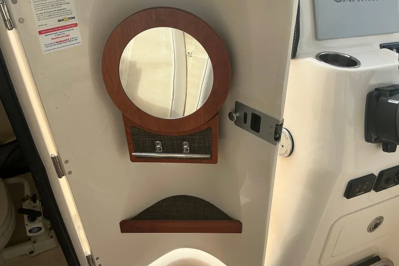 Slide: The Image of Interior of 2020 Grady-White Freedom 225 boat with mirror and storage compartment. - 14