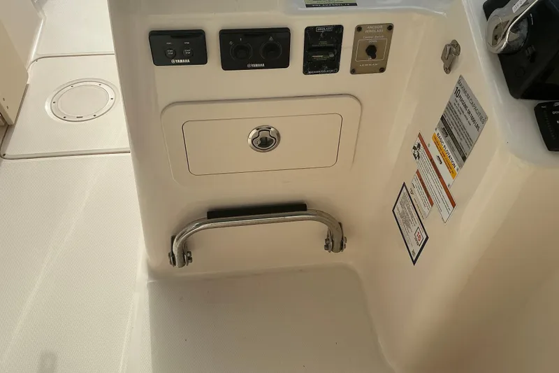 Slide: The Image of 2020 Grady-White Freedom 225 boat controls and storage compartment. - 15