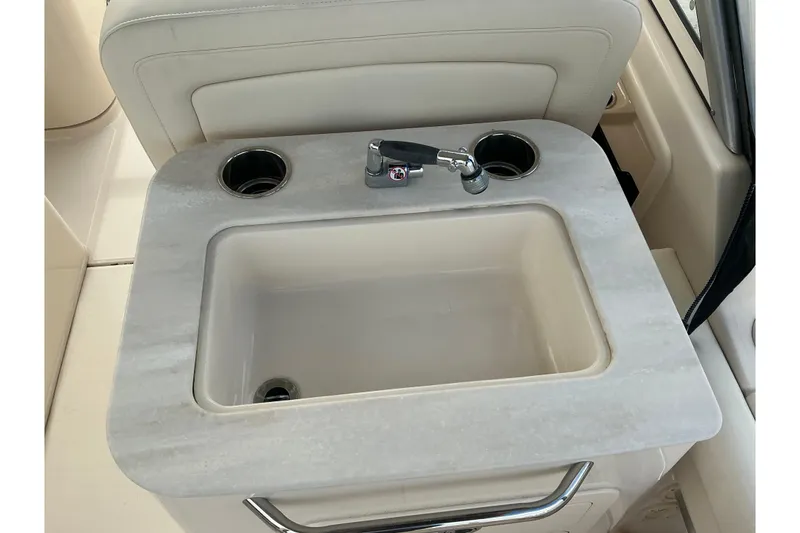Slide: The Image of 2020 Grady-White Freedom 225 boat sink with faucet and cup holders. - 17