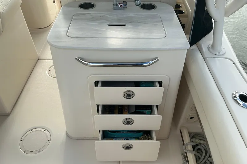 Slide: The Image of 2020 Grady-White Freedom 225 boat interior with storage drawers and countertop. - 18