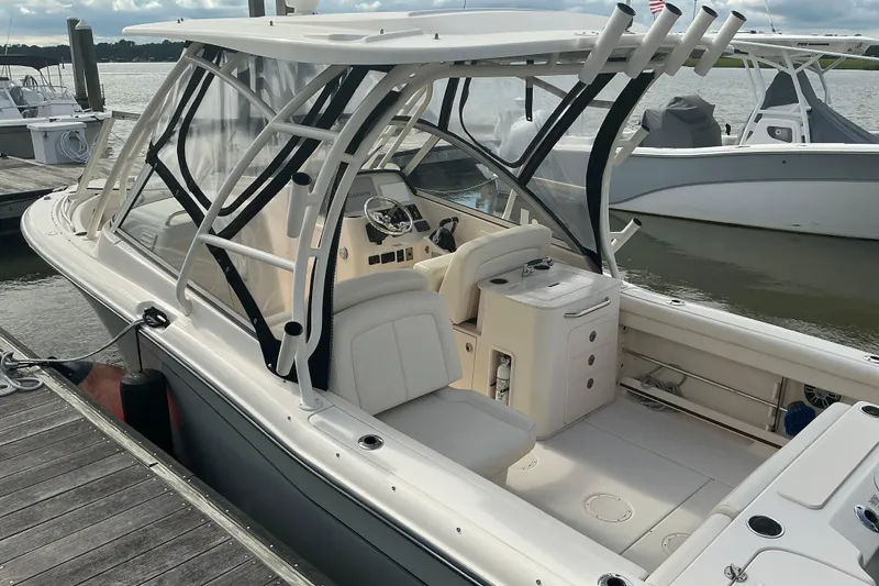 Slide: The Image of 2020 Grady-White Freedom 225 boat docked, featuring a sleek design and spacious interior. - 4