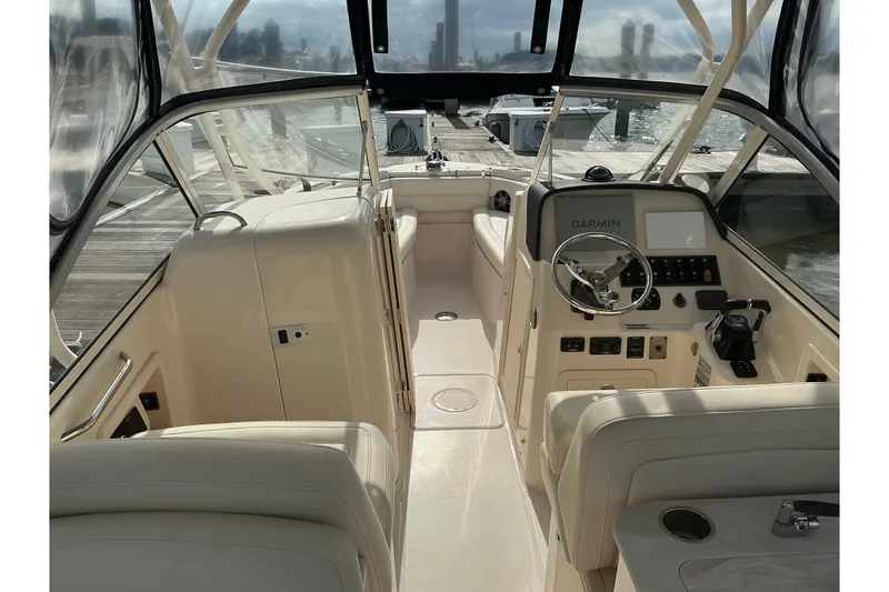 Slide: The Image of 2020 Grady-White Freedom 225 boat interior with Garmin navigation system at dock. - 6