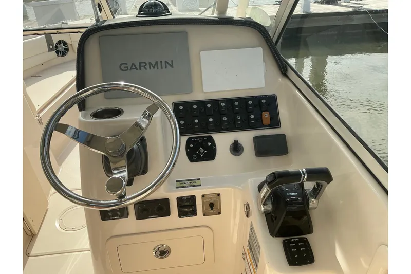 Slide: The Image of 2020 Grady-White Freedom 225 boat dashboard with Garmin navigation system and controls. - 7