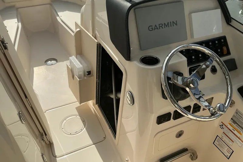 Slide: The Image of 2020 Grady-White Freedom 225 boat helm with Garmin navigation and steering wheel. - 8